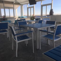 Nice glassed in area poolside that has TV's