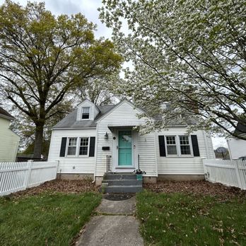 Plow and Property Projects - a white house with a blue door - General Contractors Near Me - Newington, Connecticut