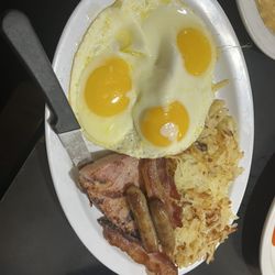 Nick's Pancake House - Eggs (Sunny side up), ham, sausage links, bacon and has browns. This with the pancakes is included in the Godfathers Breakfast