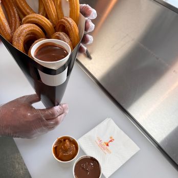 Ole Churros - a person holding a container of churros - Spanish Near Me - Paradise, Nevada Ole Churros - a person holding a container of churros - Spanish Near Me - Paradise, Nevada