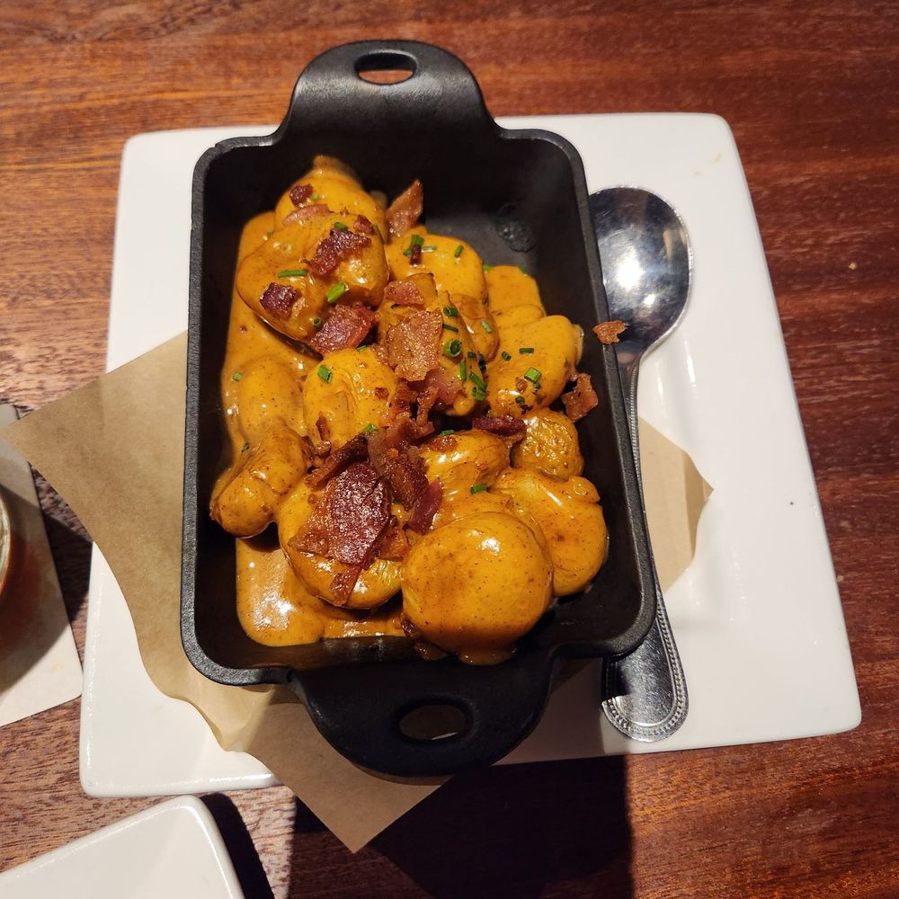 Seasons 52 - loaded small potato with sauce - New American Near Me - Schaumburg, Illinois Seasons 52 - loaded small potato with sauce - New American Near Me - Schaumburg, Illinois