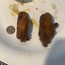 Rio's Pizza - Additional photo to show how thick the wings were compared to a penny.