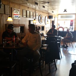 a group of people sitting at a bar a group of people sitting at a bar