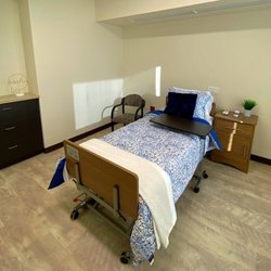 Green Valley Health & Wellness Suites - Green Valley Health and Wellness Suites resident room. All rooms come with nightstand, chair, closet, drawers, television, and phone.