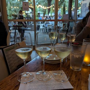 The Grove Wine Bar & Kitchen - Wine flights with the patio in the background - Pizza Near Me - Austin, Texas The Grove Wine Bar & Kitchen - Wine flights with the patio in the background - Pizza Near Me - Austin, Texas