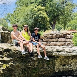 Family sitting on the falls.