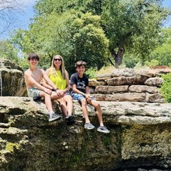 Airfield Falls Conservation Park - Family sitting on the falls.