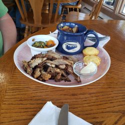 Shaved roasted pork with green vegetables, corn brad and garlic potatoes.