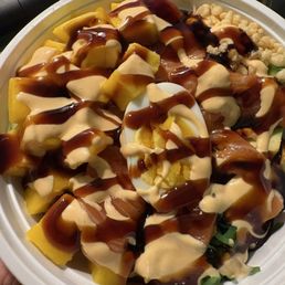 Salmon poke bowl with mango added (sauces on top) Salmon poke bowl with mango added (sauces on top)