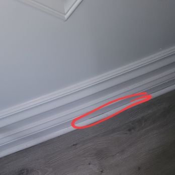 Optima Construction & Renovation - one spot (of quite a few) that they did not caulk the seam between the trim and the baseboard - Roofing Near Me - Northbrook, Illinois Optima Construction & Renovation - one spot (of quite a few) that they did not caulk the seam between the trim and the baseboard - Roofing Near Me - Northbrook, Illinois