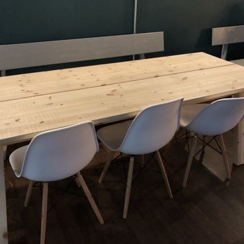 SYC Brewing - a wooden table with white chairs - Breweries Near Me - Edmonton, Alberta SYC Brewing - a wooden table with white chairs - Breweries Near Me - Edmonton, Alberta