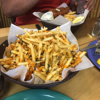 Coconuts Fish Cafe - Basket of volcano fries- fries with sirracha sauce and seasoning. - Seafood Near Me - Kihei, Hawaii Coconuts Fish Cafe - Basket of volcano fries- fries with sirracha sauce and seasoning. - Seafood Near Me - Kihei, Hawaii