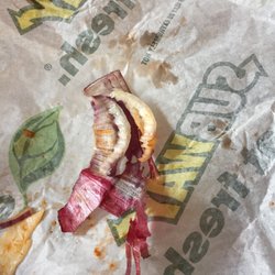 Disgusting onion skin on a soggy, cold meatball sub