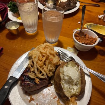 Cattlemens Steakhouse - Rib eye steak and baked potato with fried onion - Steakhouses Near Me - Redding, California