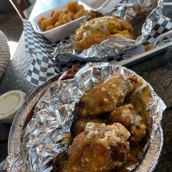 Taste budzz - a plate of chicken wings and a bowl of tater tots - American Near Me - Phoenix, Arizona