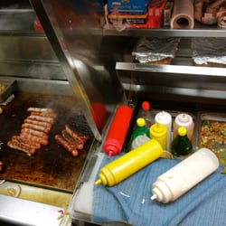 Bacon Wrapped Hot Dogs with Onions, Peppers, Avocado, Pico de Gallo and Grilled Jalapeno.