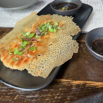 Fúdo - Dumplings pictured underneath an edible garnish. Staple item but the garnish is a twist! - Asian Fusion Near Me - Chamblee, Georgia Fúdo - Dumplings pictured underneath an edible garnish. Staple item but the garnish is a twist! - Asian Fusion Near Me - Chamblee, Georgia