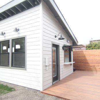 CV Construction - a white house with a wood deck - General Contractors Near Me CV Construction - a white house with a wood deck - General Contractors Near Me