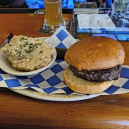 A hard, dry burger and mushy potato dumpling. A hard, dry burger and mushy potato dumpling.