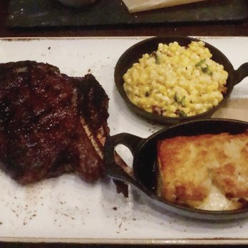 J Gilbert's - Bone in rib eye, creamed corn with bacon, poblano au gratin potatoes - Bars Near Me - Omaha, Nebraska J Gilbert's - Bone in rib eye, creamed corn with bacon, poblano au gratin potatoes - Bars Near Me - Omaha, Nebraska