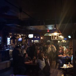 people sitting at tables in a bar