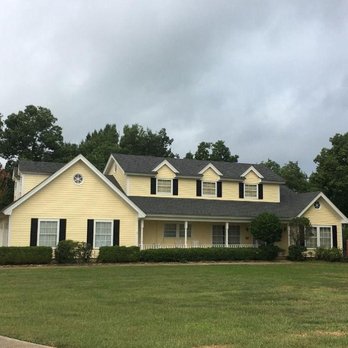 H2 Renovations & Contracting - a yellow house with black shutters - Painters Near Me