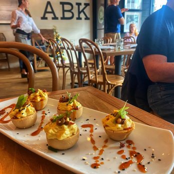 AB Kitchen - RAMEN DEVILED EGGS  Nueske's bacon, spicy Japanese BBQ sauce, scallions, sesame. - New American Near Me - Atlantic Beach, Florida