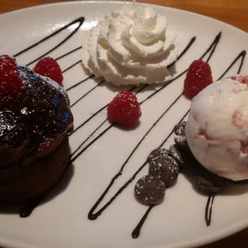 Cutters Crabhouse - The chocolate dessert of the day - Chocolate Lava Cake with a raspberry on top, vanilla-raspberry ice cream and whipped cream. - Seafood Near Me - Seattle, Washington Cutters Crabhouse - The chocolate dessert of the day - Chocolate Lava Cake with a raspberry on top, vanilla-raspberry ice cream and whipped cream. - Seafood Near Me - Seattle, Washington