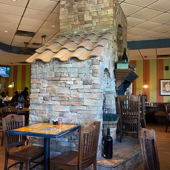 Elizabeth's Pizza - Wood burning fireplace in middle.  They run it in the winter - Italian Near Me - Greensboro, North Carolina