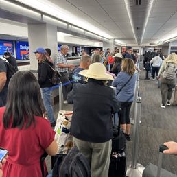 The line waiting for a car and they only have two people working and at least 10 empty stations