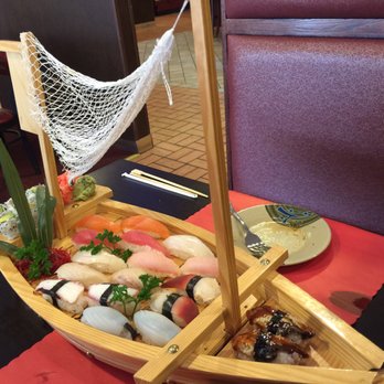 Kira's Asian Bistro - a wooden boat filled with sushi - Asian Fusion Near Me - Burlington, Wisconsin