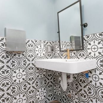 LUXE Cabinets and Design - Wishbone floor tile and beautiful wall pattern tile. Copper accents in all restrooms . - Cabinetry Near Me - Santa Ana, California