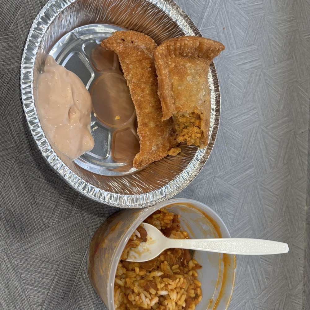 Chicken, empanadas, rice, and beans.