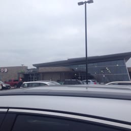 cars parked in front of a tim hortons store