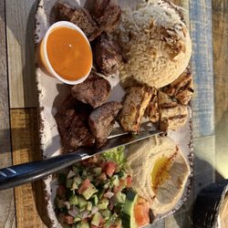 Beef, Lamb and Chicken kabobs with rice, hummus, veggies.