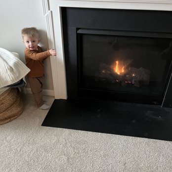 Genes - Our son modeling our "hot" working fireplace! - Heating & Air Conditioning/HVAC Near Me - Medina, Ohio