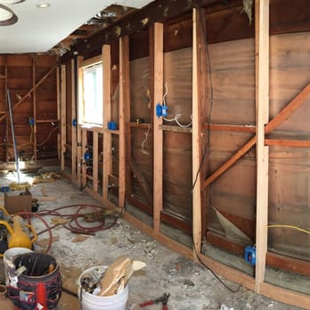 Dan Construction and Maintenance - Fixing 2 leaning walls. See the bottom of the new wood studs shifted out by 2.5 inch to make the wall vertically straight? - General Contractors Near Me