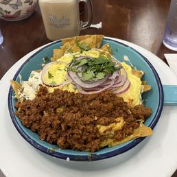 Green chilaquiles with scrambled eggs and chorizo. Green chilaquiles with scrambled eggs and chorizo.
