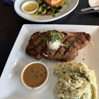 Salt At Geist - 16oz ribeye with Parmesan risotto and grilled salmon filet on a bed of Brussels sprouts - Wine Bars Near Me - Fishers, Indiana Salt At Geist - 16oz ribeye with Parmesan risotto and grilled salmon filet on a bed of Brussels sprouts - Wine Bars Near Me - Fishers, Indiana