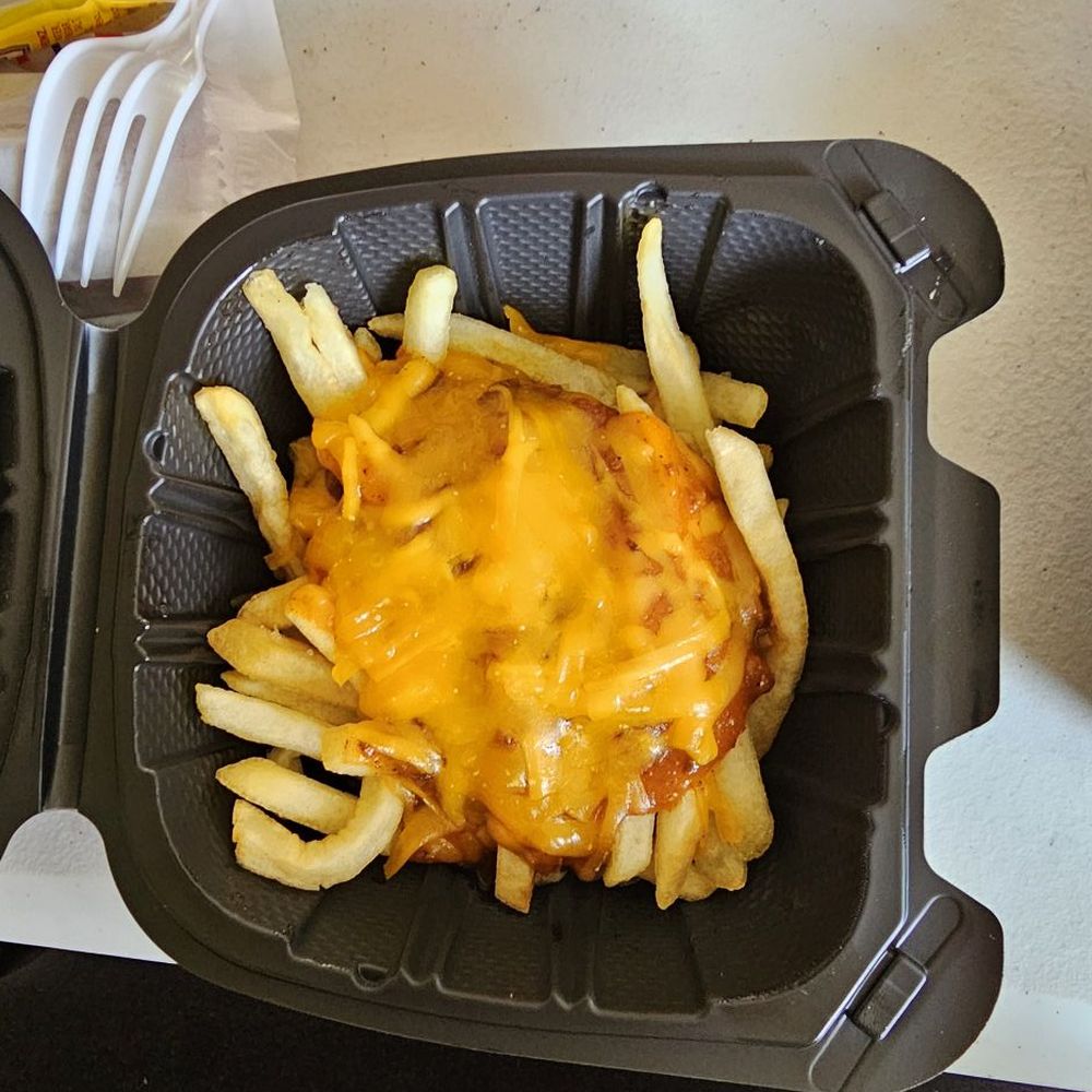 Couple of fries under glop of chili Couple of fries under glop of chili