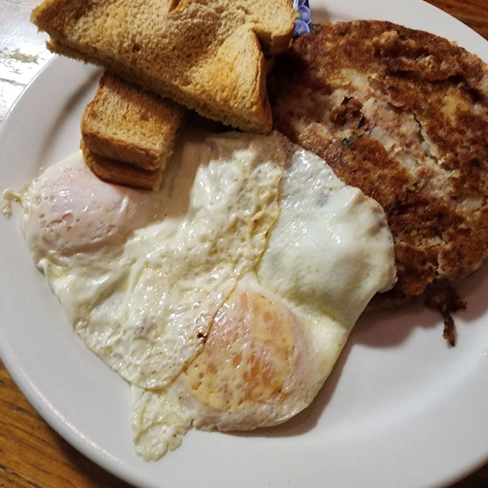 Corned beef hash with over easy eggs and toast Corned beef hash with over easy eggs and toast