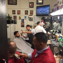 Grinding away at the tonsorial arts! Always a fresh cut and a short wait with these men going at it... Grinding away at the tonsorial arts! Always a fresh cut and a short wait with these men going at it...