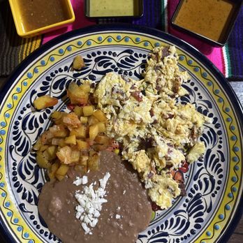 MariLuz Cocina Mexican - Eggs and bacon with a side of refried beans and potatoes - Mexican Near Me - Alvin, Texas MariLuz Cocina Mexican - Eggs and bacon with a side of refried beans and potatoes - Mexican Near Me - Alvin, Texas
