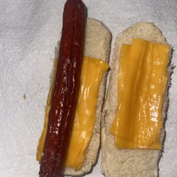 a hot dog with cheese and mustard a hot dog with cheese and mustard