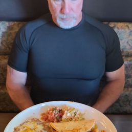 Shrimp tacos.... he looks surprised at all the food. Lol Shrimp tacos.... he looks surprised at all the food. Lol