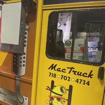 Mac Truck - a man standing in front of a food truck - Food Trucks Near Me Mac Truck - a man standing in front of a food truck - Food Trucks Near Me