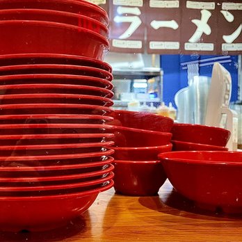 Maru Ramen - a stack of red bowls and plates - Ramen Near Me - Ithaca, New York Maru Ramen - a stack of red bowls and plates - Ramen Near Me - Ithaca, New York