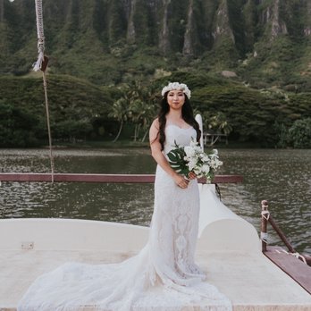 Golden Thread Alterations - Bride standing on a catamaran crossing a fish pond in Hawaii - Sewing & Alterations Near Me - Livermore, California