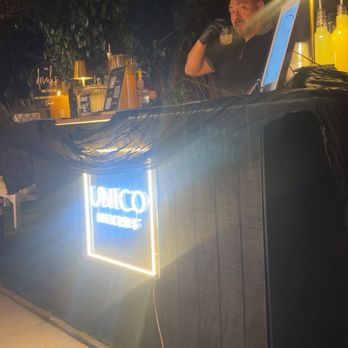 Unico Mixers - Black bar with modern sign - Bartenders Near Me