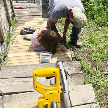 Prime Time Contracting - a man and a woman cutting wood - General Contractors Near Me Prime Time Contracting - a man and a woman cutting wood - General Contractors Near Me